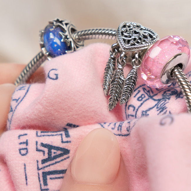 Silver Charm Bracelet Being Polished with Town Talk Polishing Cloth Close-Up